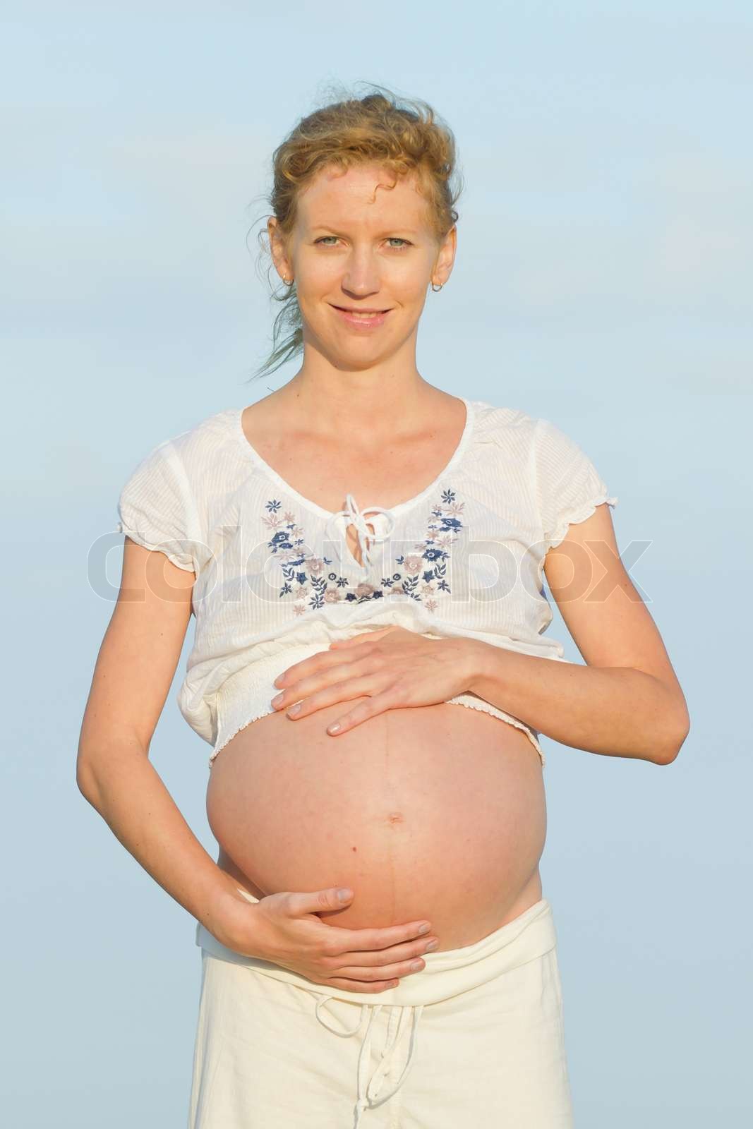 beautiful pregnant woman on a beach Stock image Colourbox