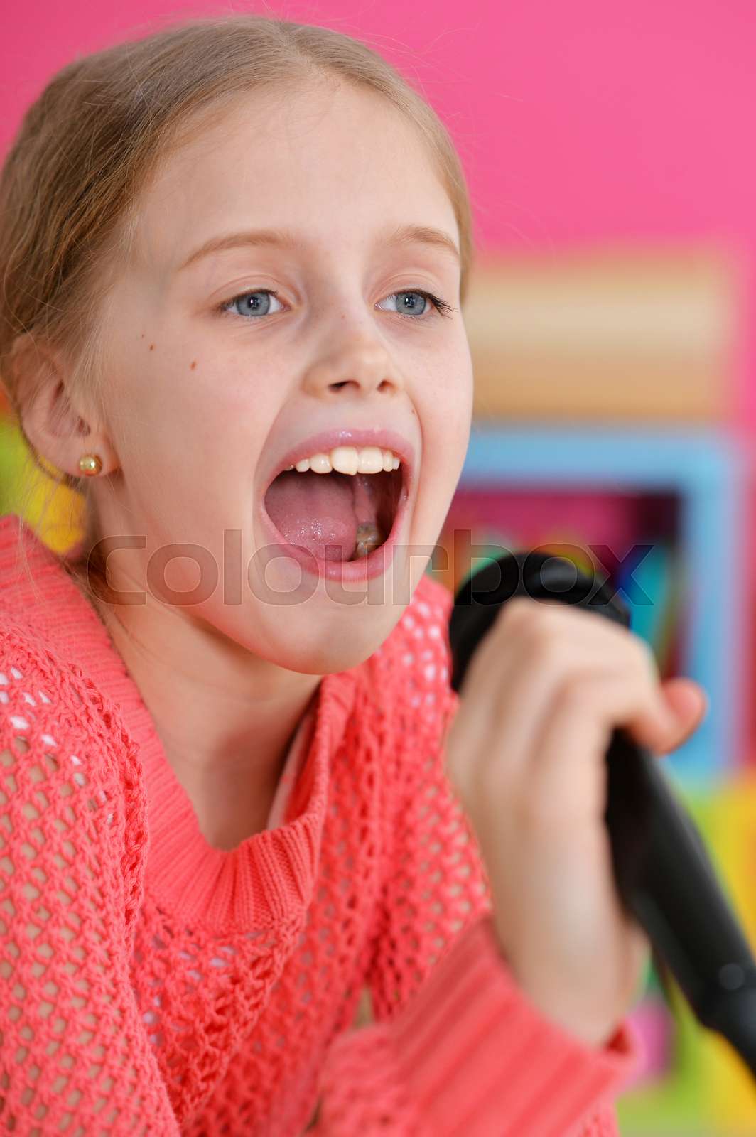 little girl singing with microphone | Stock image | Colourbox