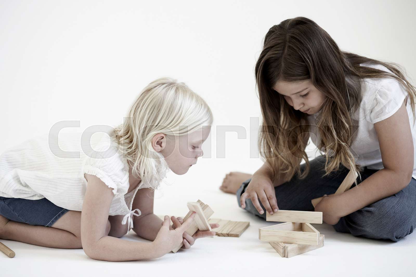 Young girls playing with building blocks | Stock image | Colourbox