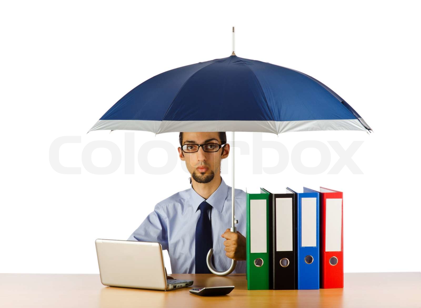 Businessman holding umbrella in the office Stock image Colourbox