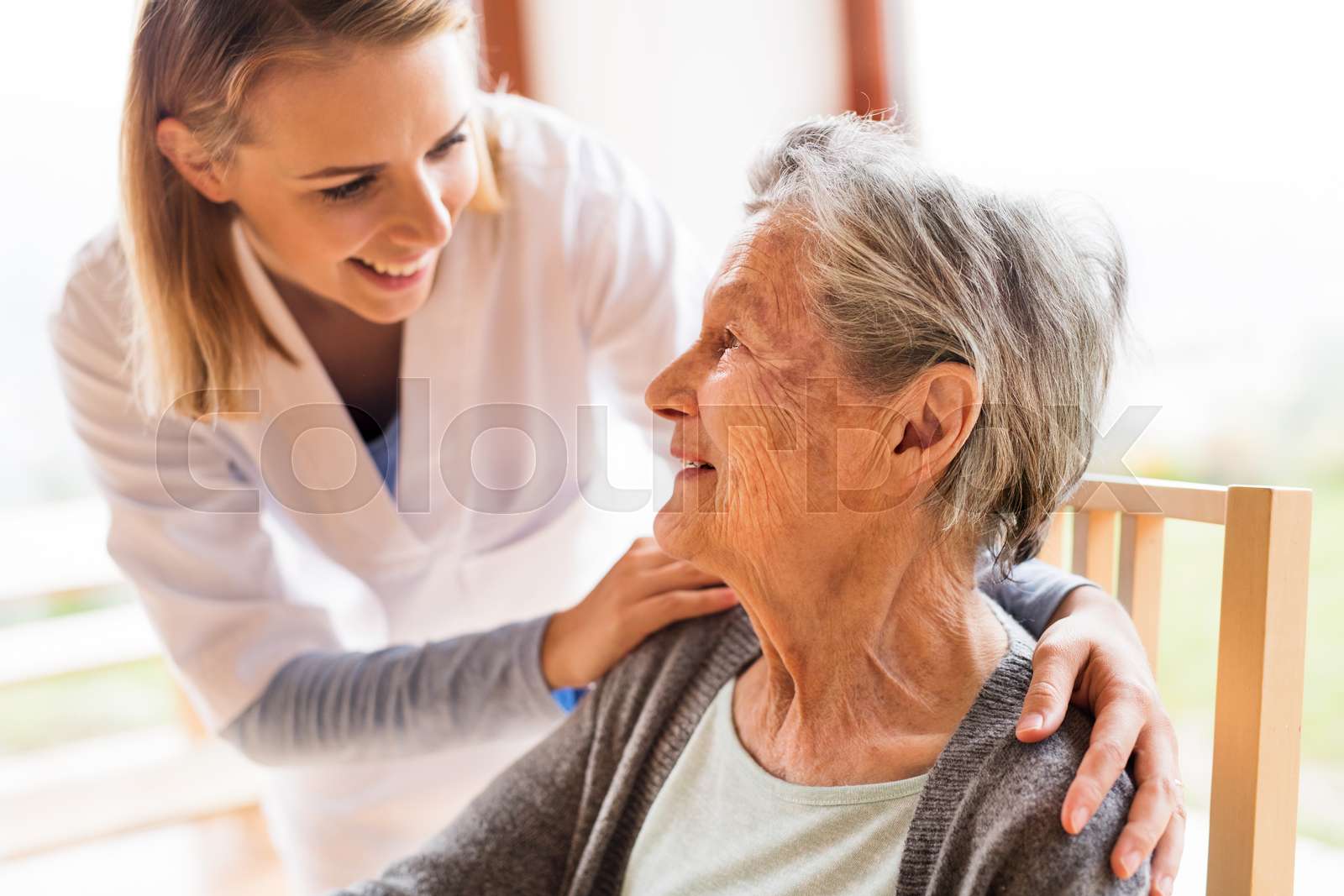Health Visitor And A Senior Woman During Home Visit Stock Image 