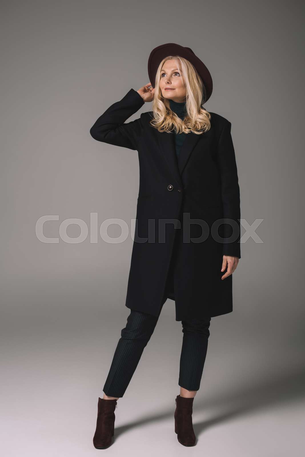 mature woman in coat and hat | Stock image | Colourbox