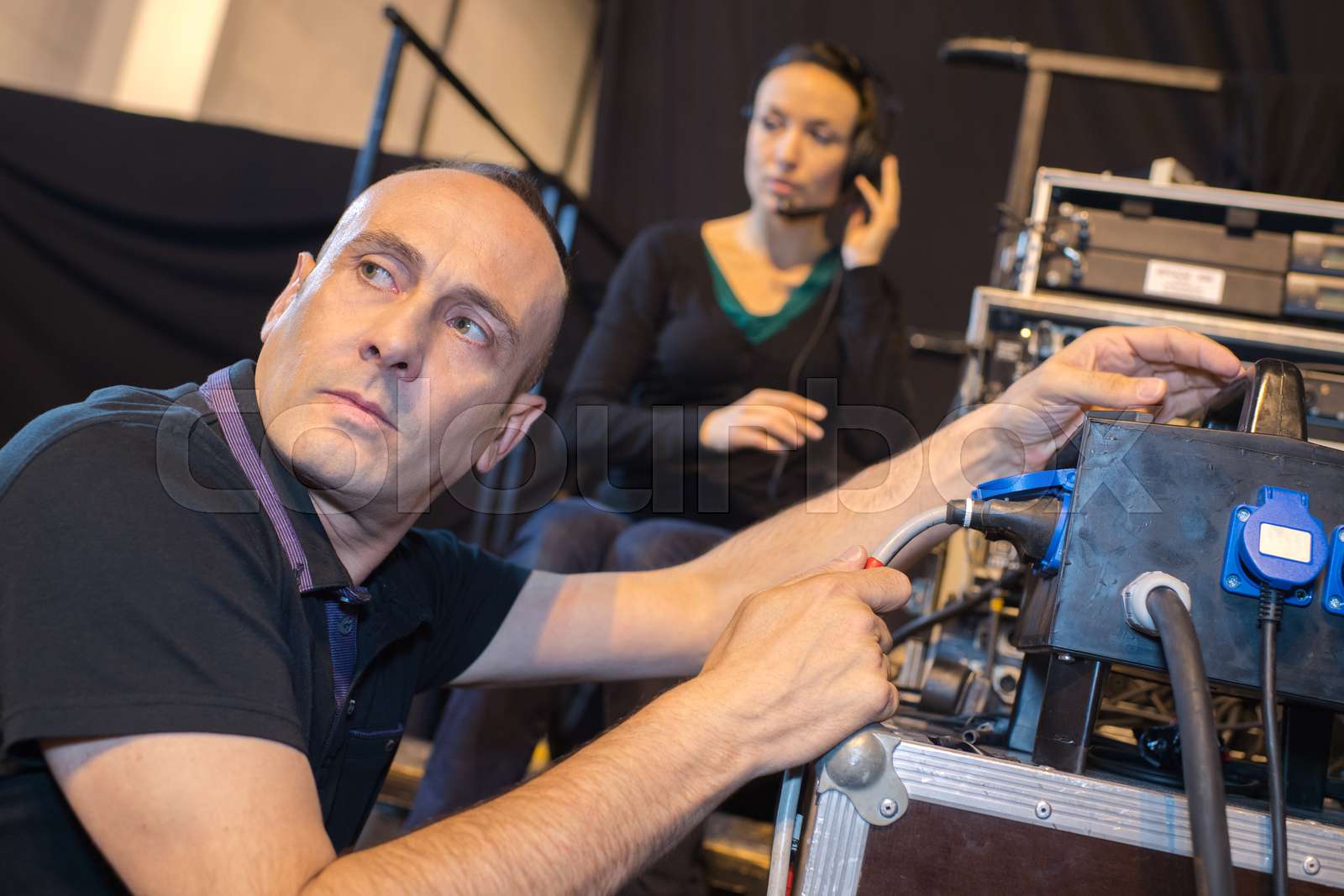 sound engineer working at mixing panel in recording studio Stock