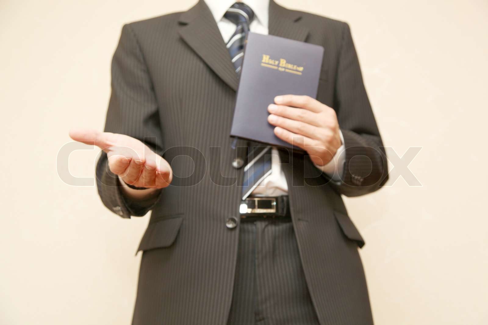 Man in suit with Holy Bible Stock image Colourbox