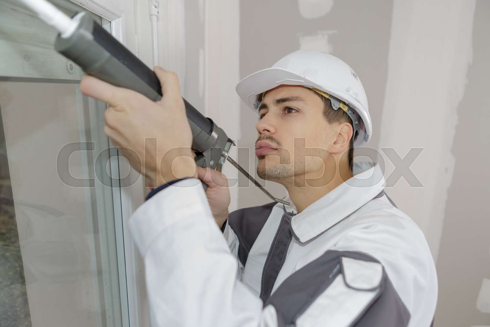 Glazier installing the new window stock image colourbox