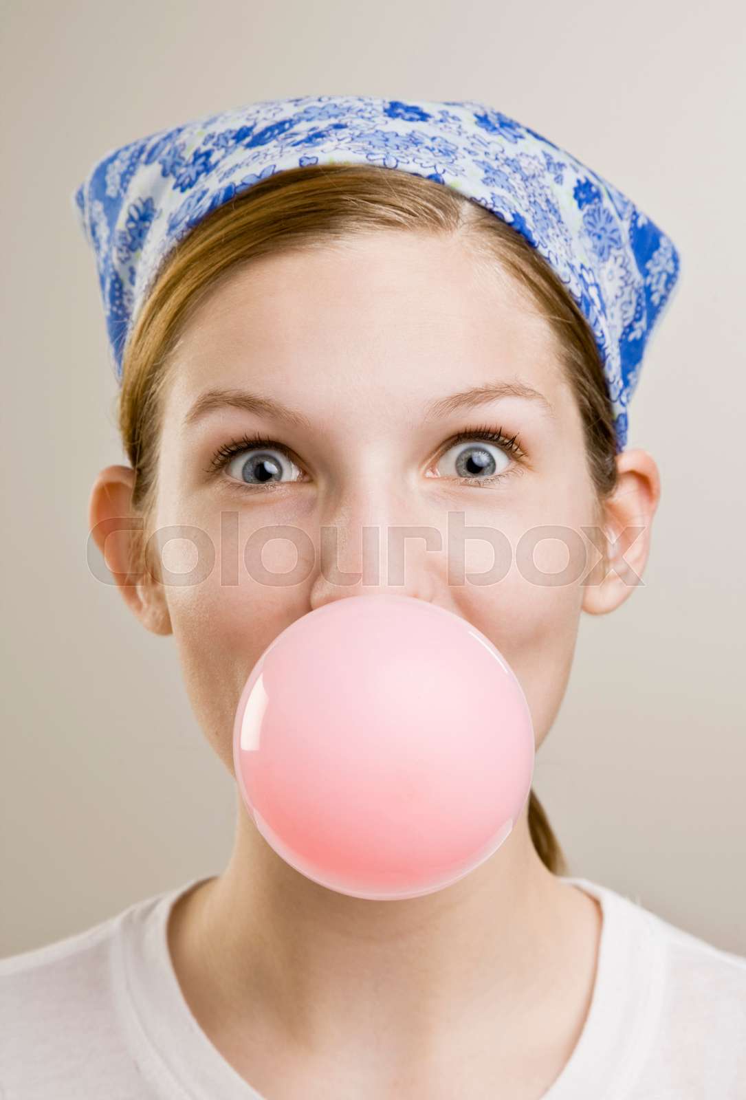 Woman blowing a bubble with gum | Stock image | Colourbox