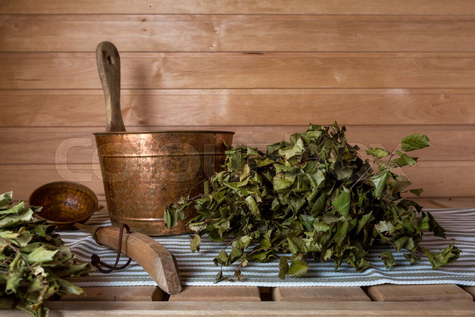 A bucket of water and a birch bath whisk in a traditional Finnish sauna ...
