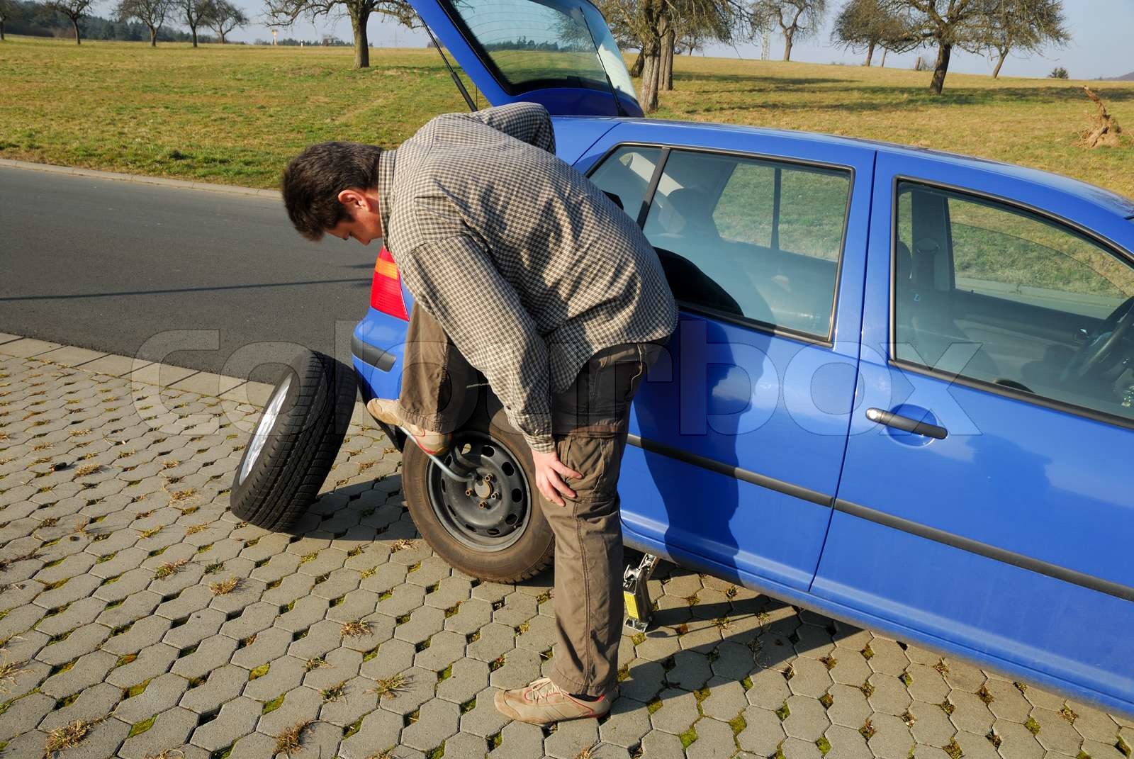Changing a tire on the road Stock image Colourbox