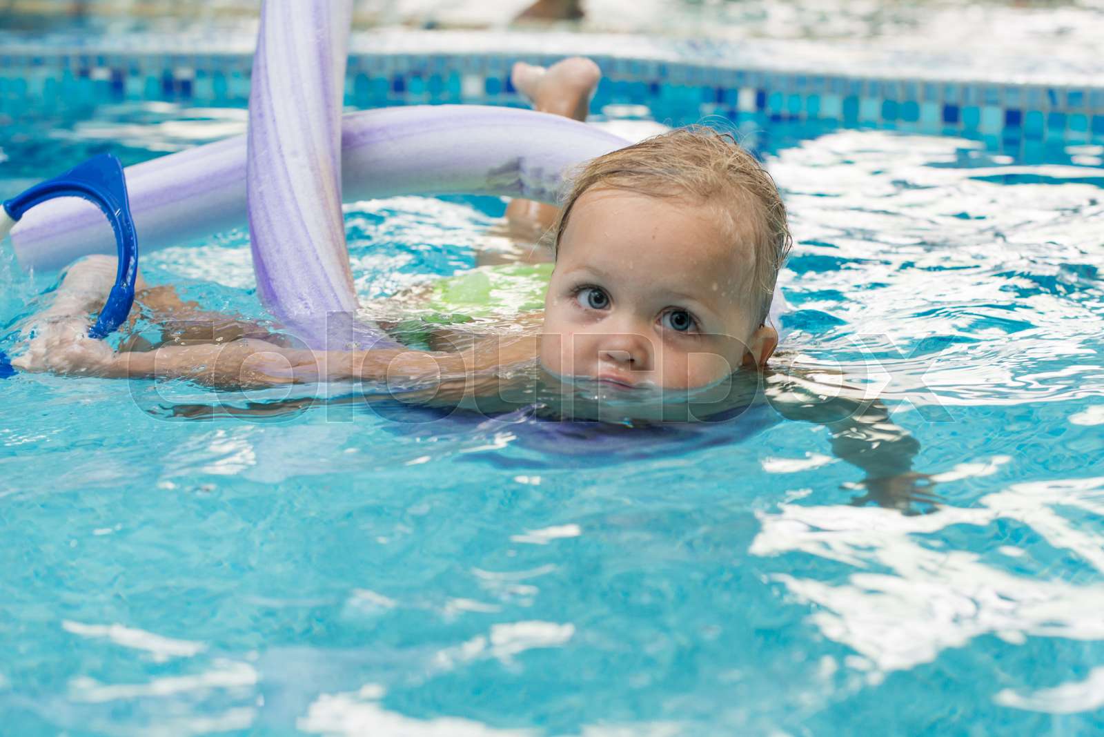 Happy little girl learning to swim with pool noodle | Stock image ...