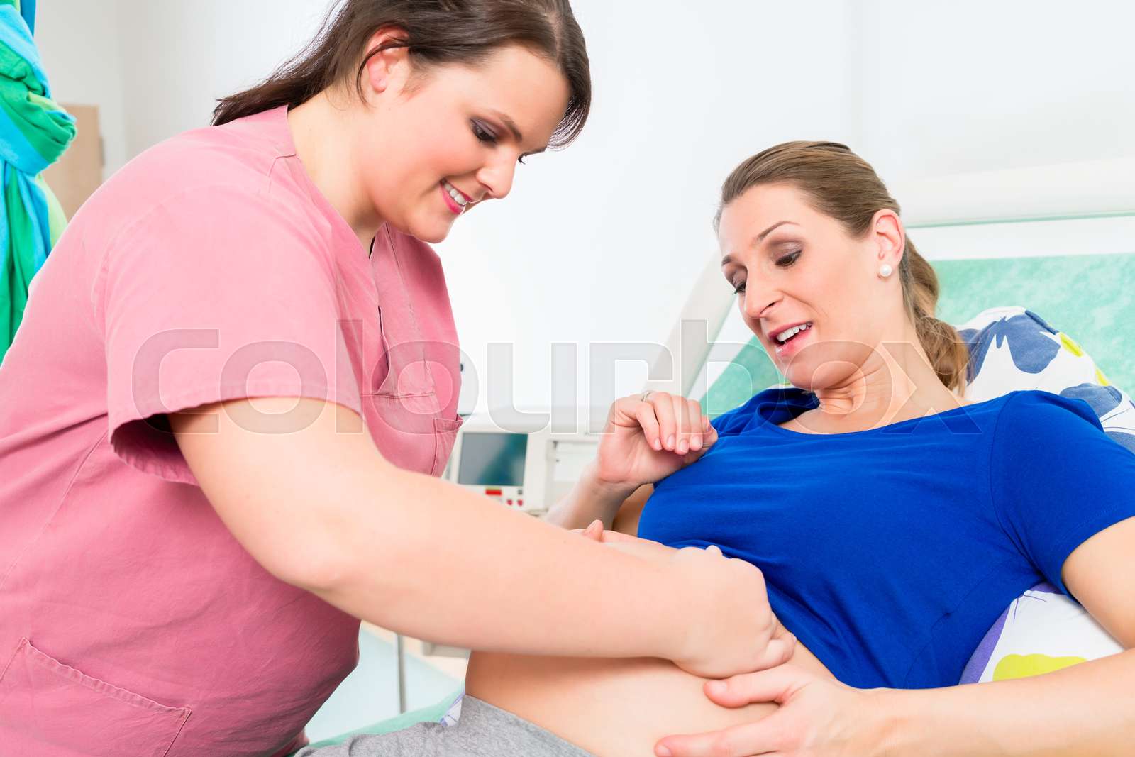 Midwife or nurse and pregnant woman in delivery room | Stock image