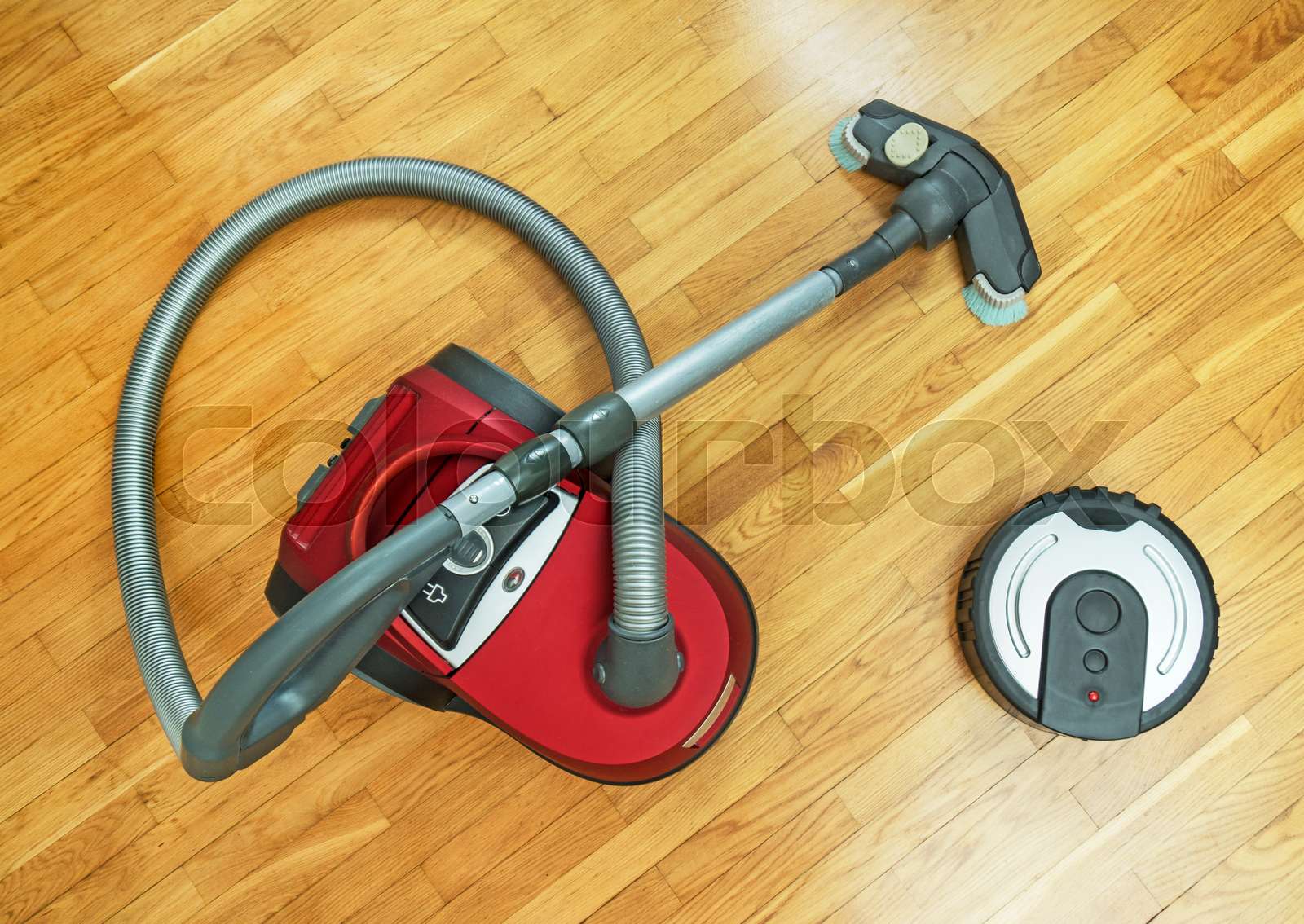 Robotic vacuum cleaner vs Vacuum cleaner. Stock image Colourbox
