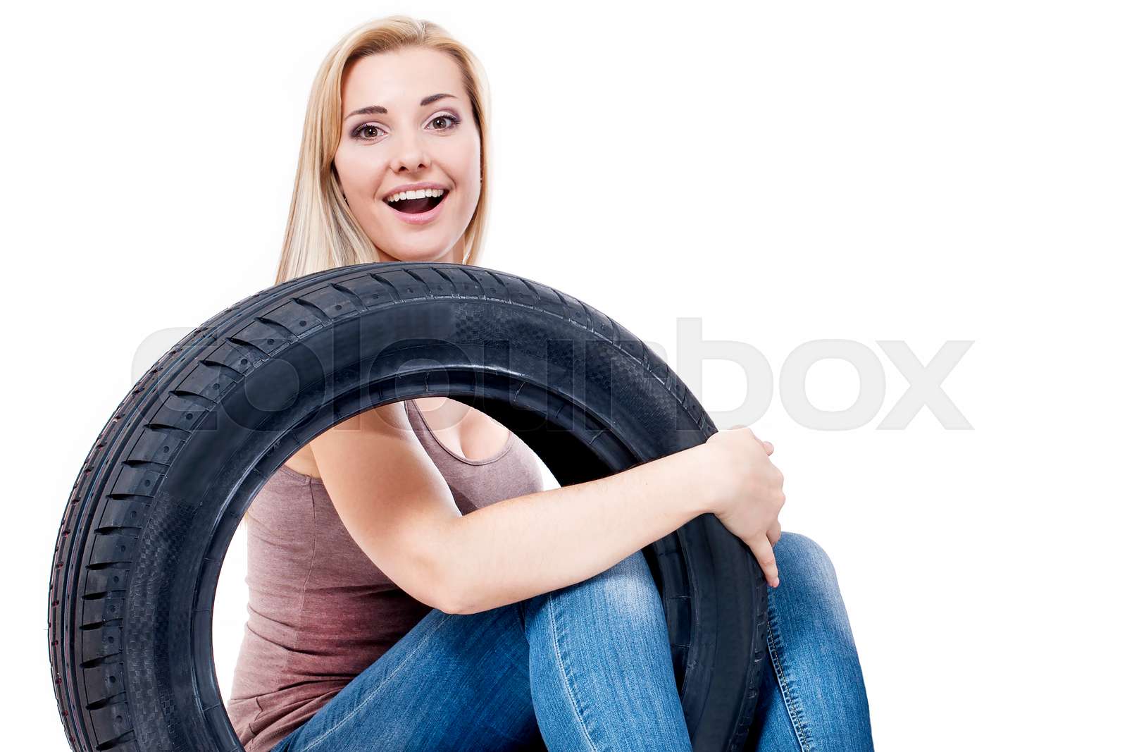 Tire. Woman with car wheels | Stock image | Colourbox