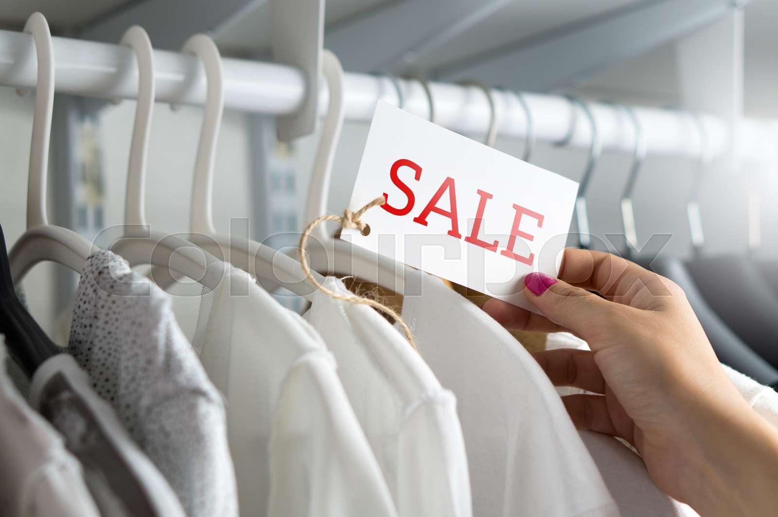 Female customer browsing clothes | Stock image | Colourbox