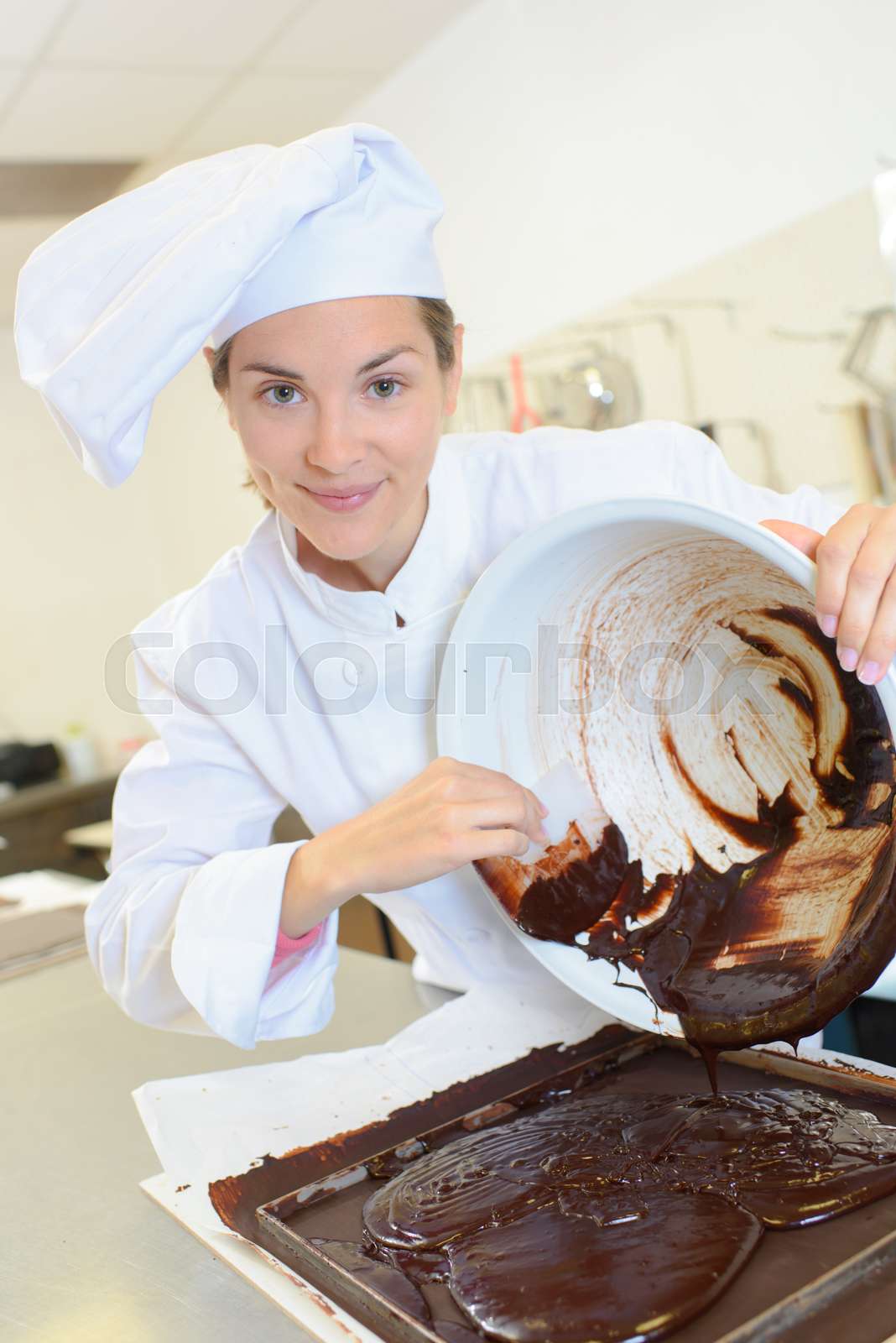 chef-scraping-chocolate-mixture-into-baking-tray-stock-image-colourbox