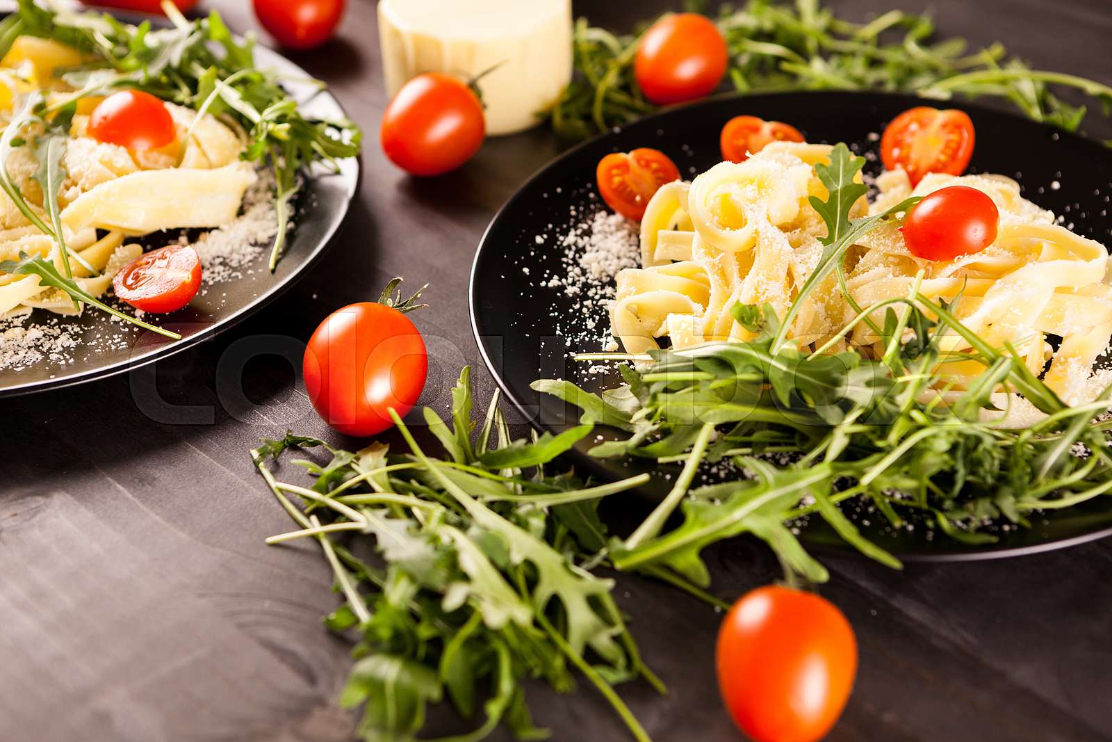 Italian pasta in black plates | Stock image | Colourbox
