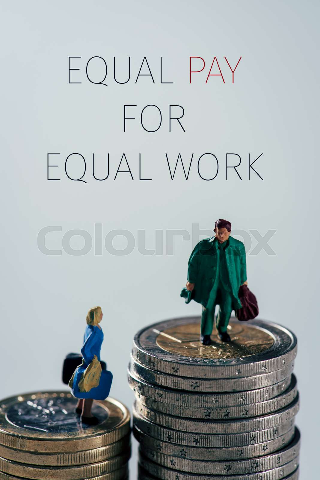 miniature people and text equal pay for equal work | Stock image