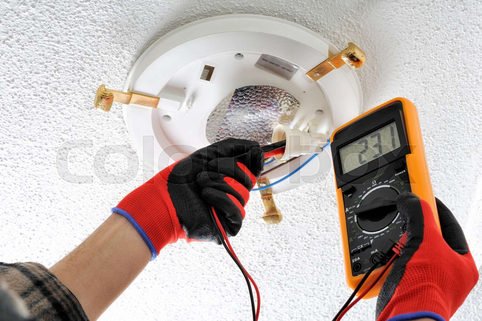 Electrician technician at work on a residential electric system Stock