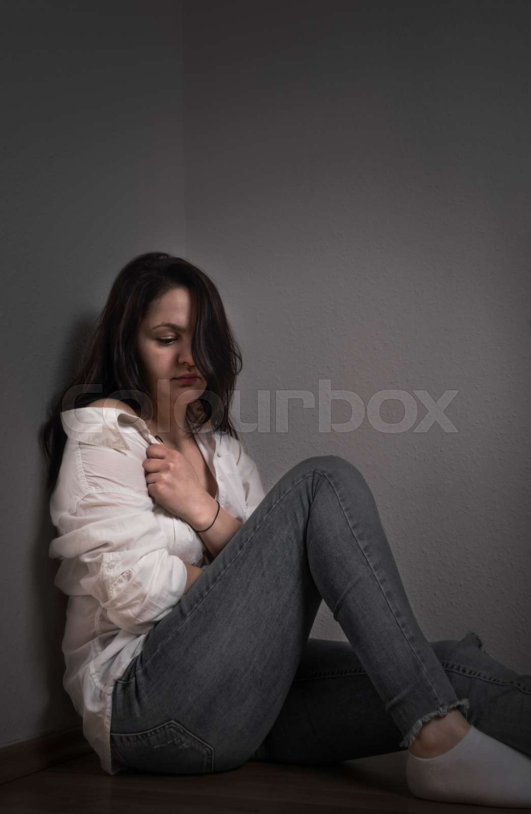 Woman pulling her shirt Stock image Colourbox