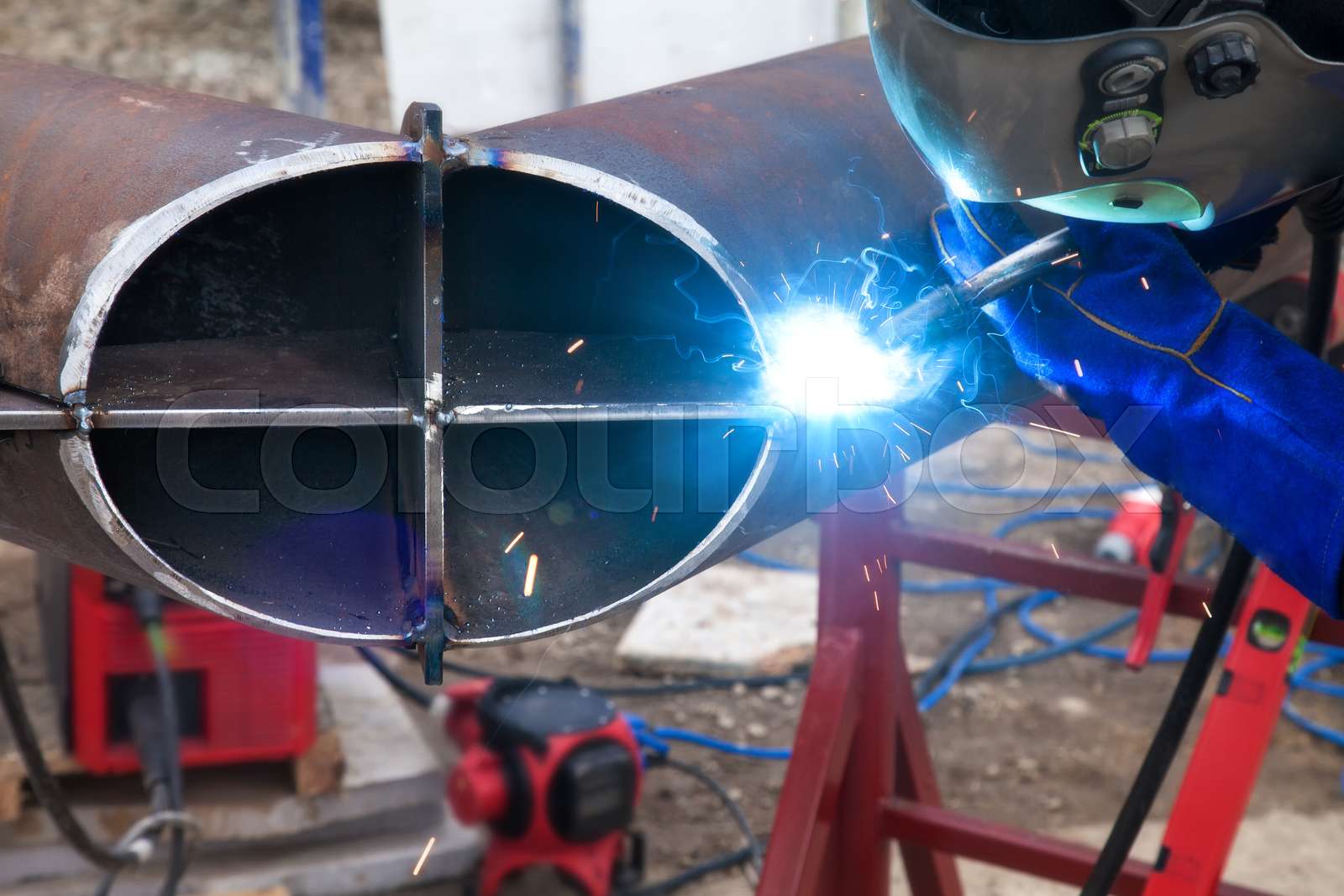 Worker welding in a factory. Welding on an industrial plant. Stock