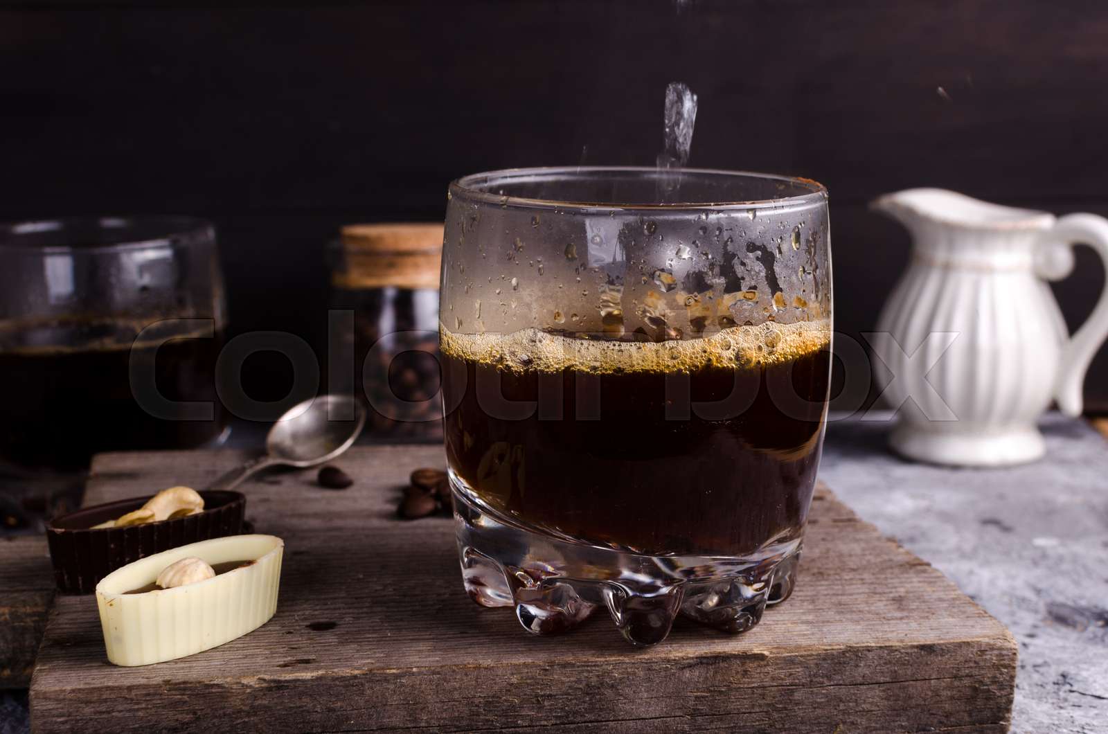 pouring boiling water into a glass of coffee Stock image Colourbox