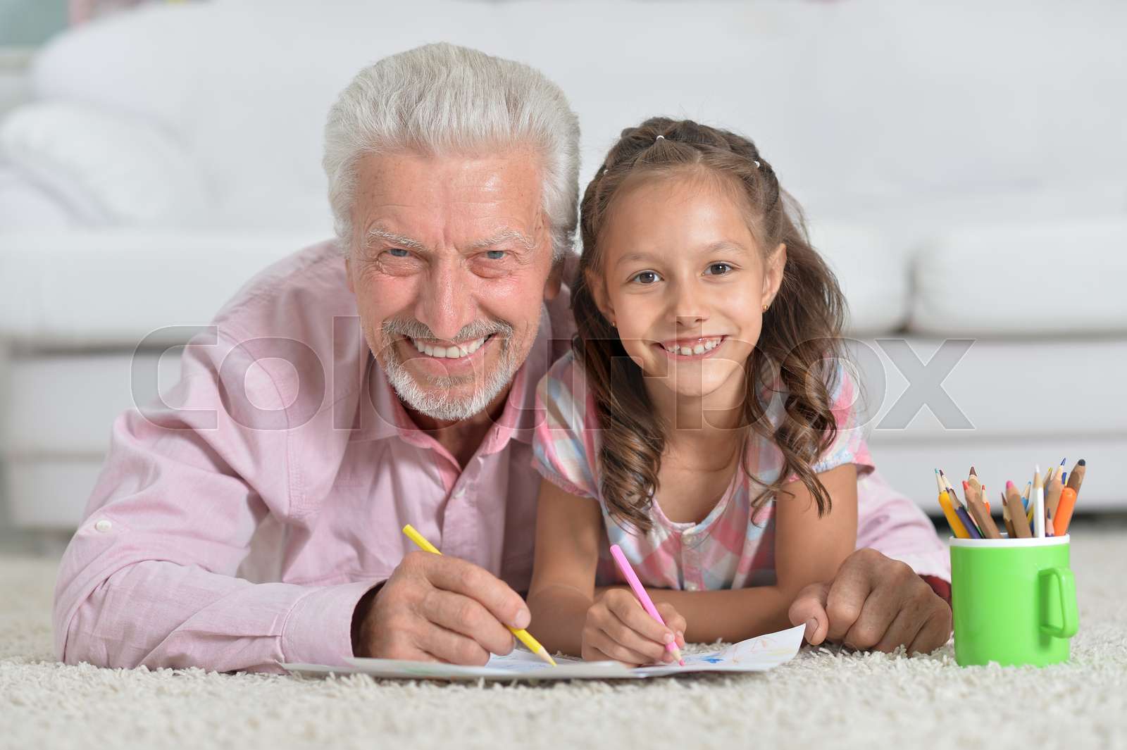 Grandfather drawing with granddaughter Stock image Colourbox