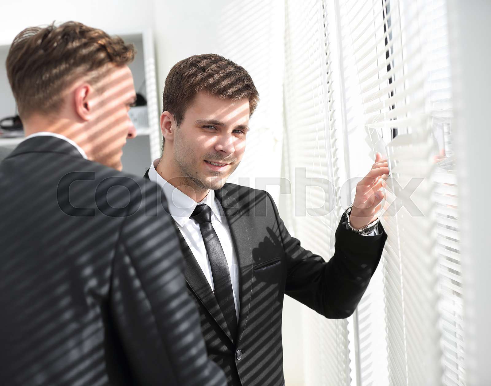 business people look in the window office | Stock image | Colourbox