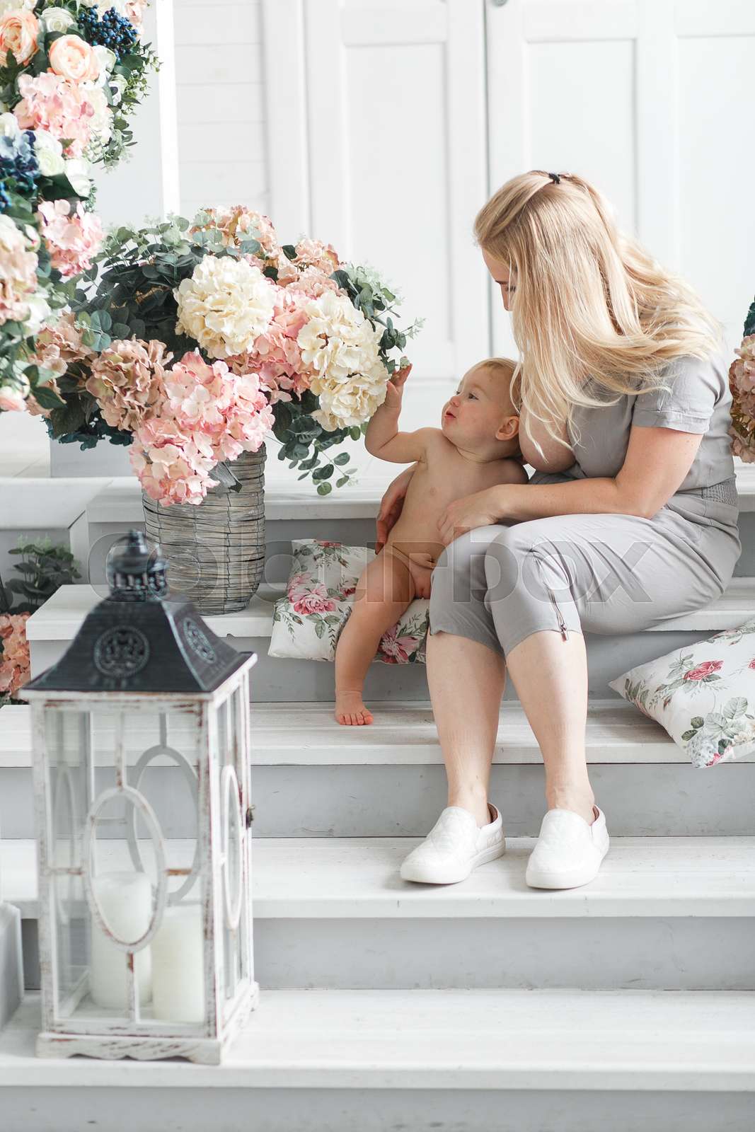 beautiful mother with big breast breastfeeding her baby while sitting ...