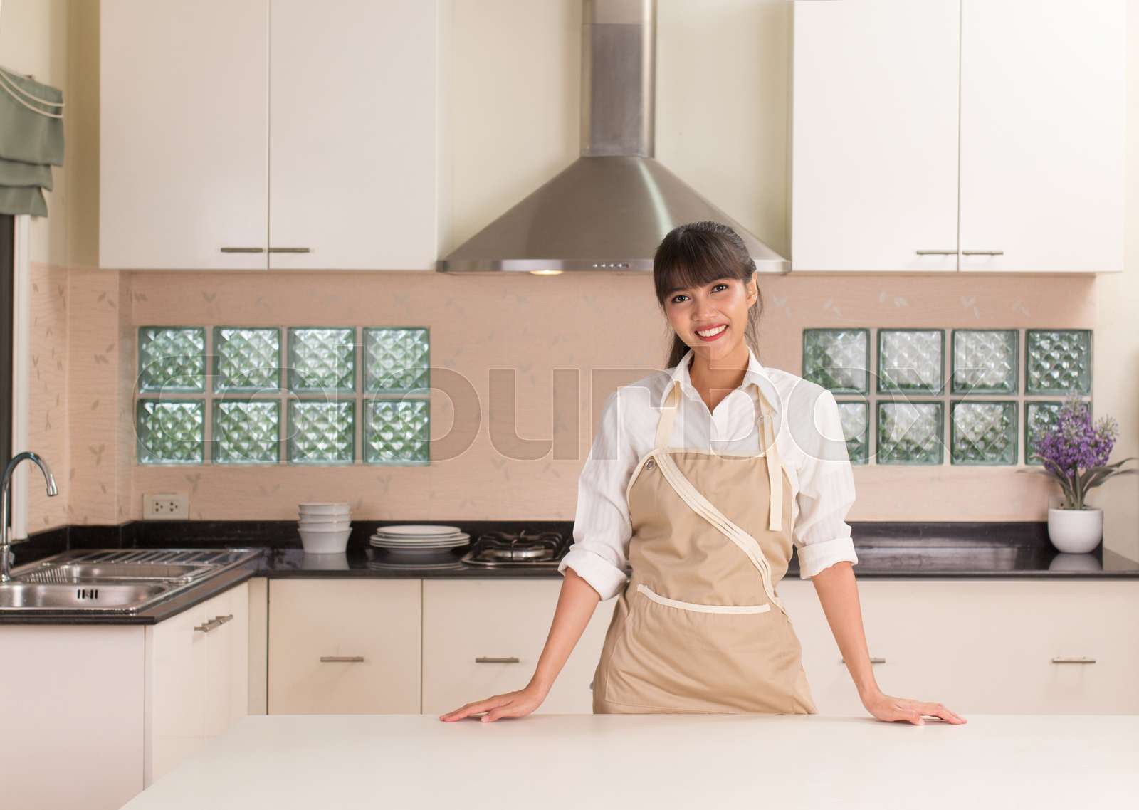 Young Woman Preparing To Cooking In The Modern Kitchen Style Stock