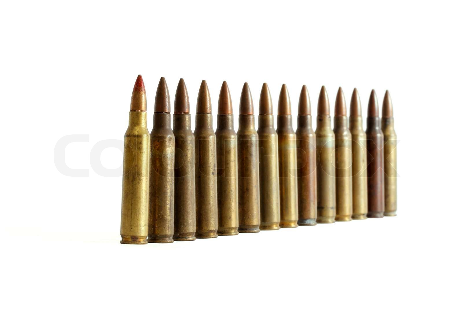 Row of standing M16 cartridges converging in perspective with shallow ...