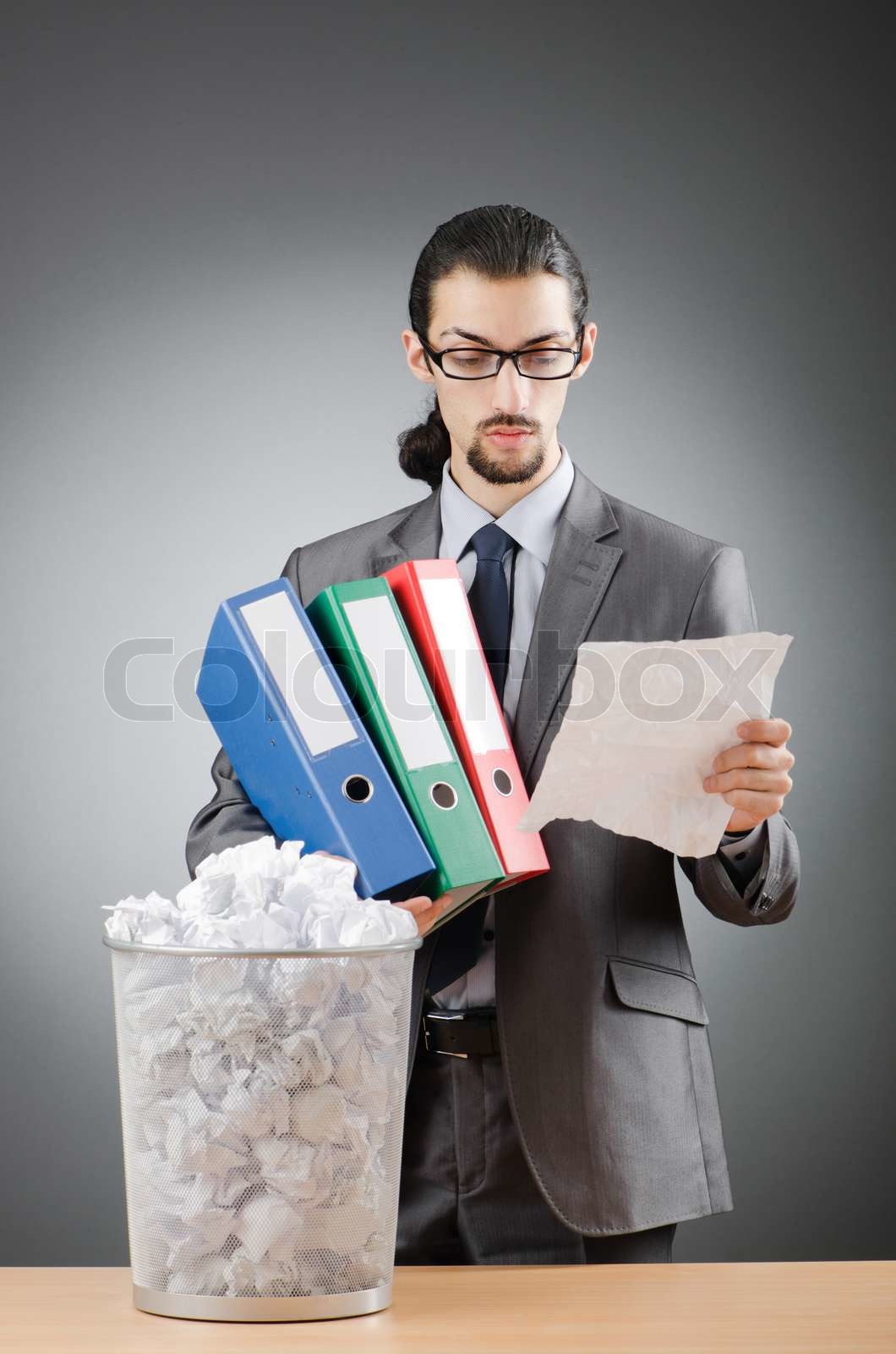 Man with lots of wasted paper | Stock image | Colourbox