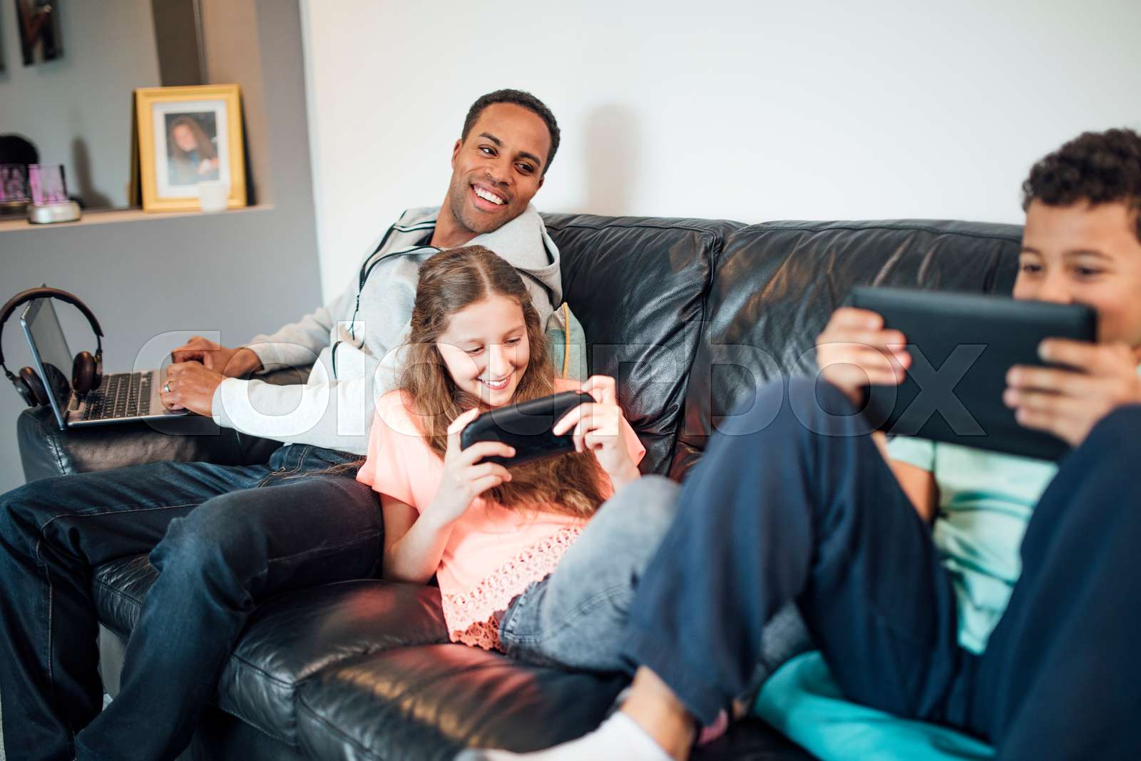 Family Using Technology at Home | Stock image | Colourbox