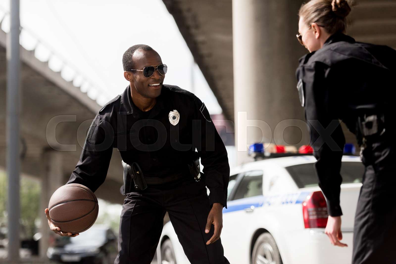young police officers playing basketball near car | Stock image | Colourbox