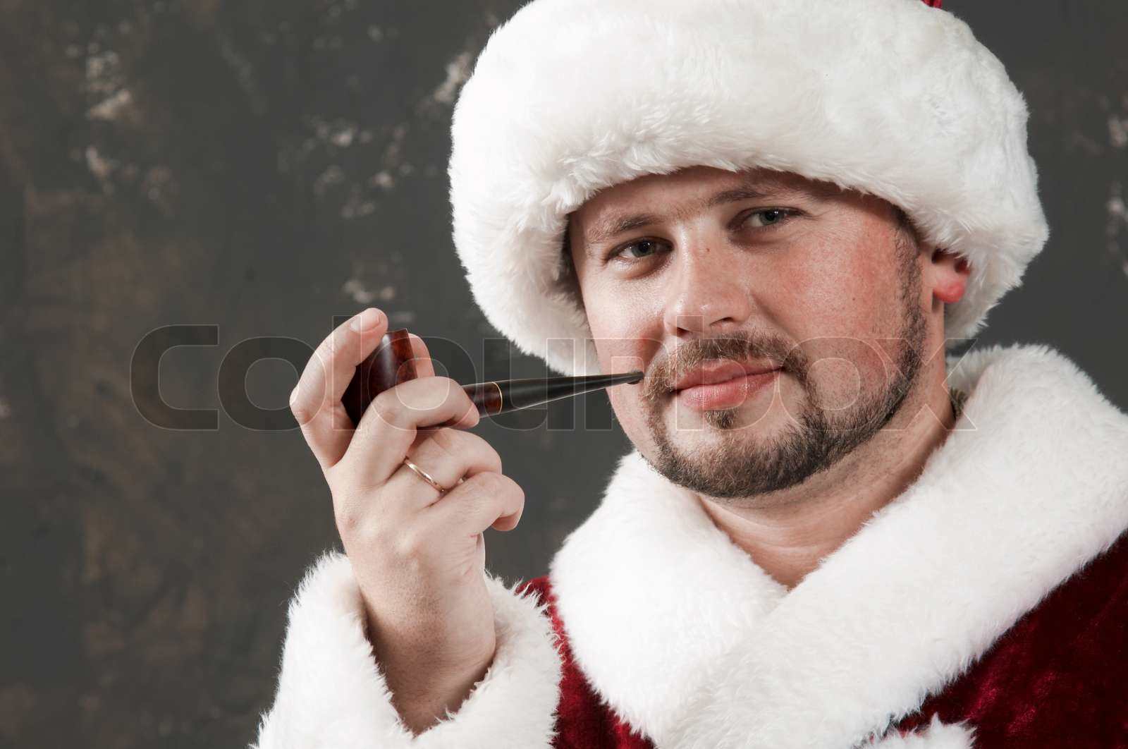 Santa Claus is preparing to celebrate Christmas. Smoking Stock image