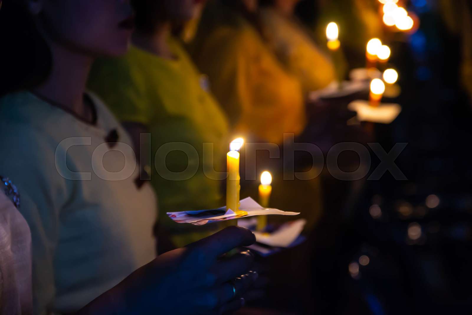 People hold candles light at night Stock image Colourbox