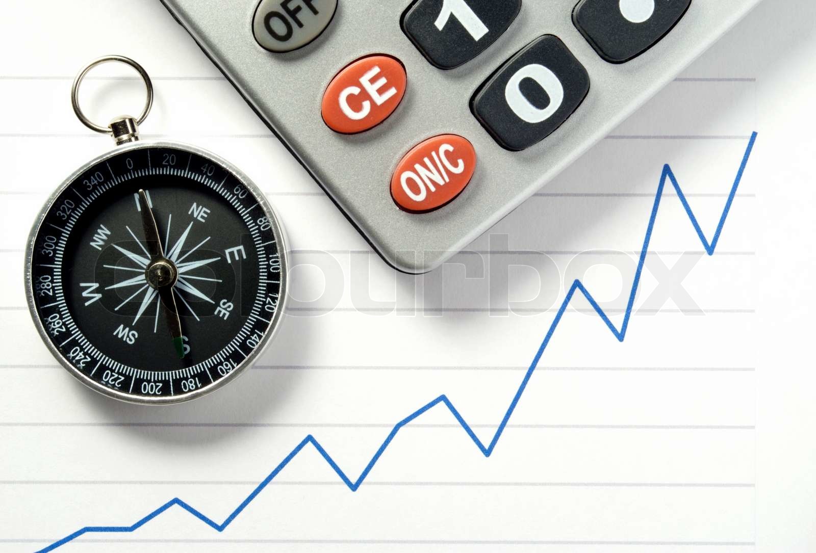 calculator, a compass and a chart on a sheet of paper Stock image