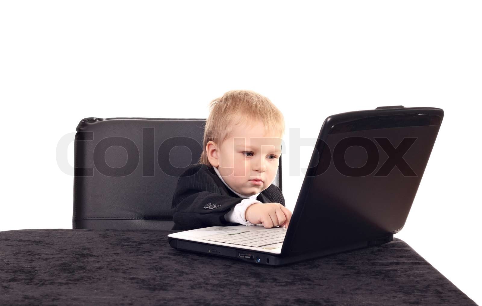 Little businessman working with computer | Stock image | Colourbox