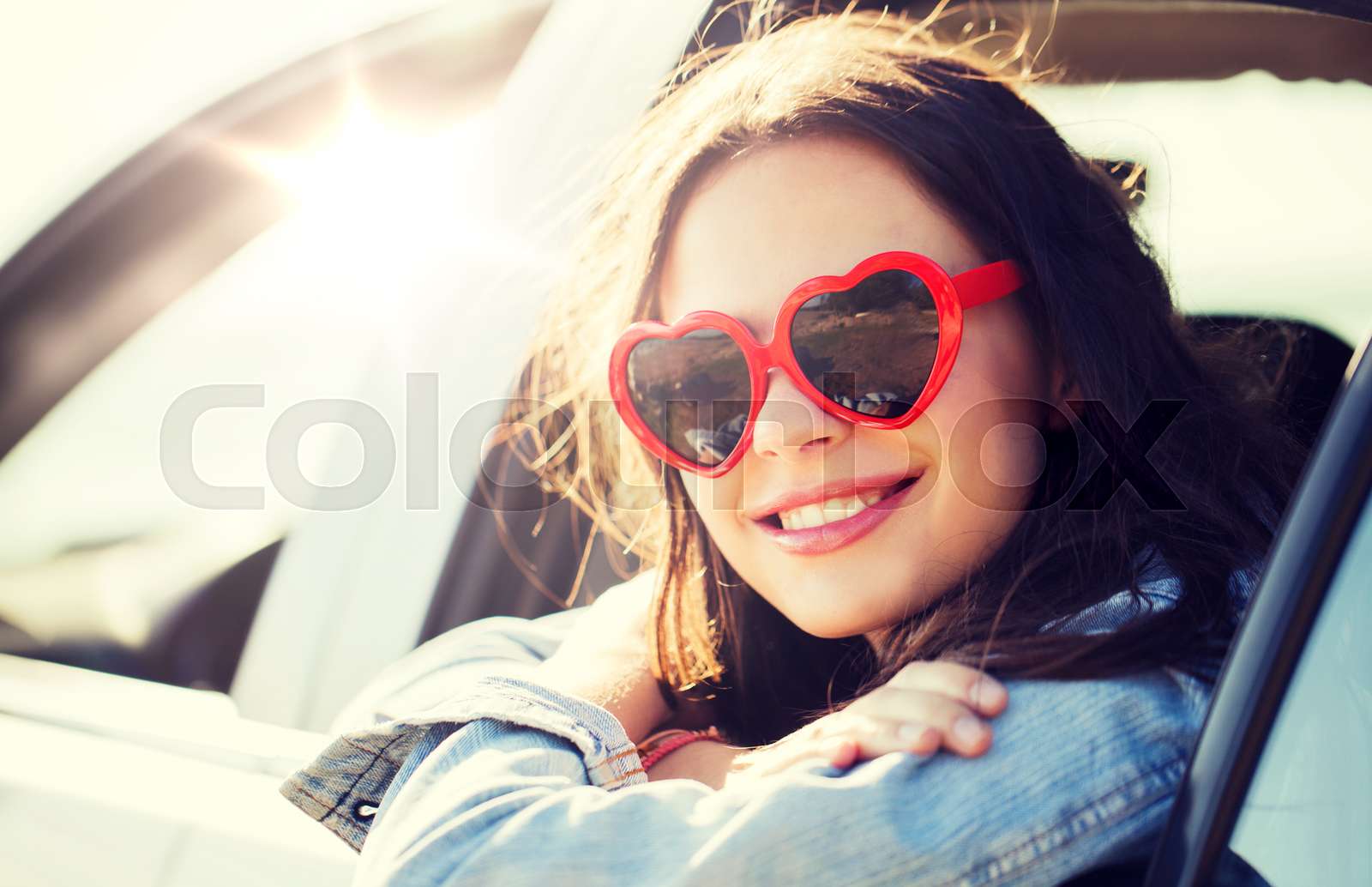 happy teenage girl or young woman in car | Stock image | Colourbox