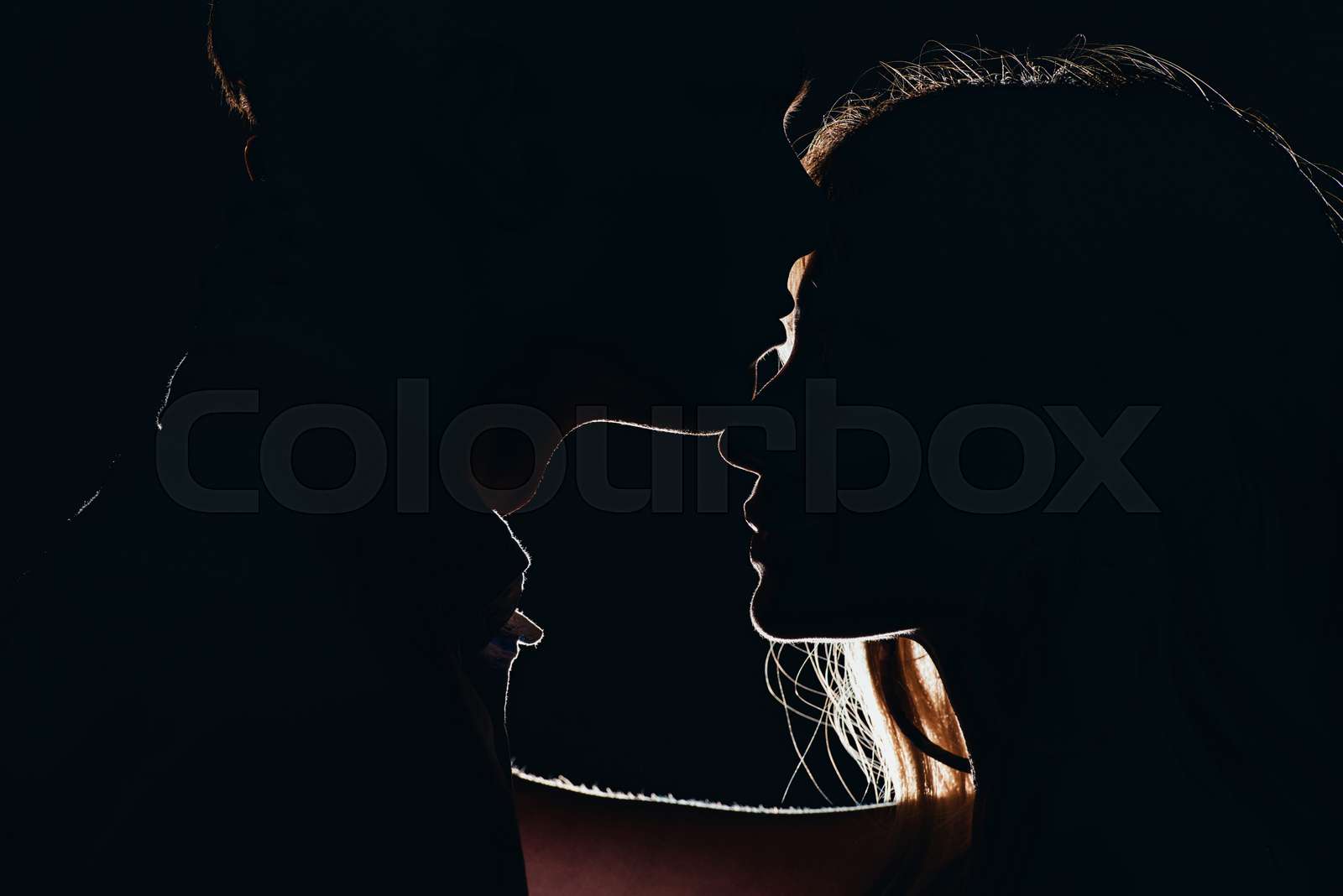 Silhouettes Of Young Tender Couple In Dark Stock Image Colourbox