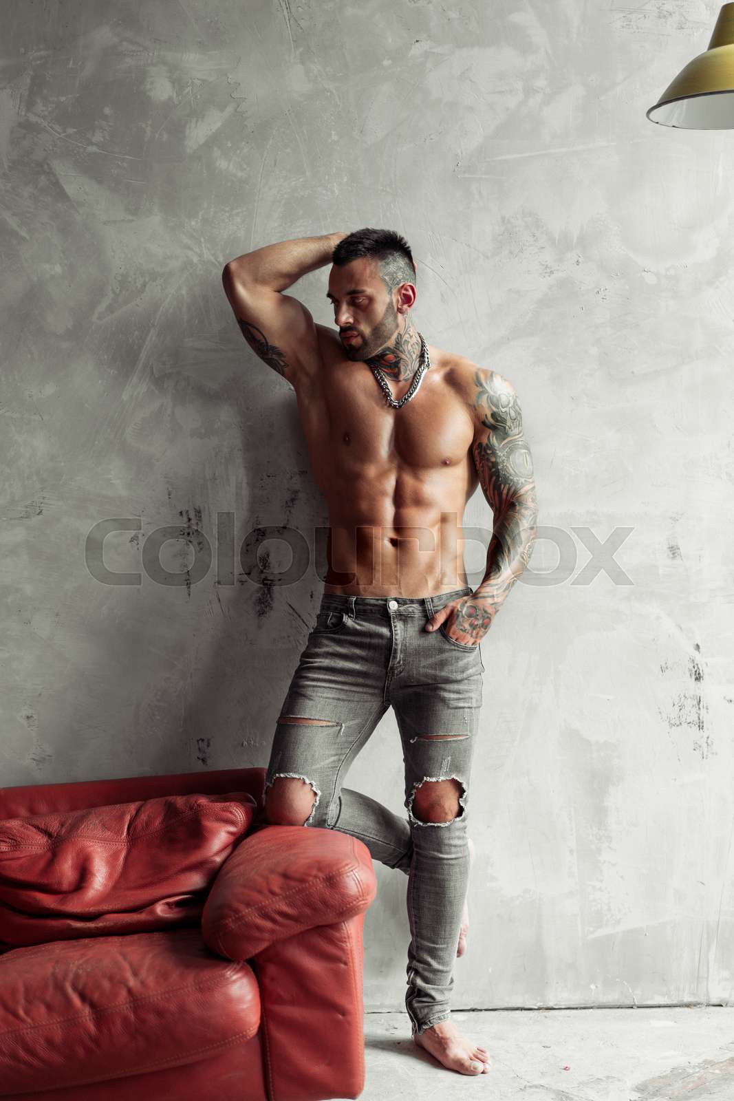 Fashion portrait of Sexy naked male model with tattoo and a black beard