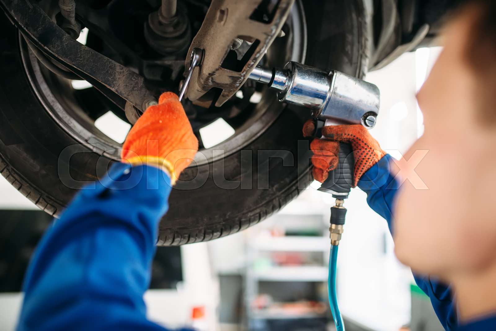 Technician with a wrench repair car suspension Stock image Colourbox