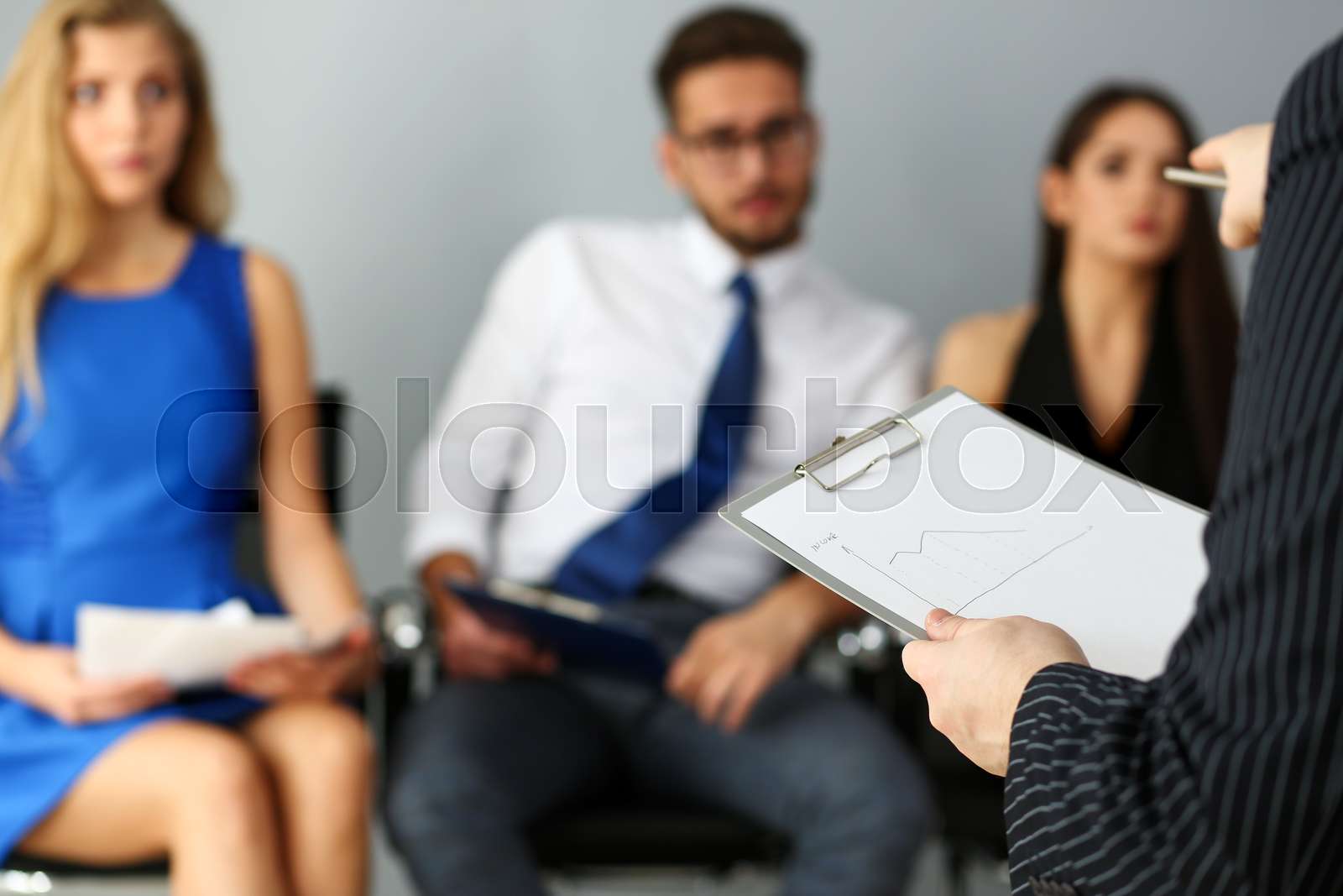 Group of people sit on casting chairs row at boss reception Stock