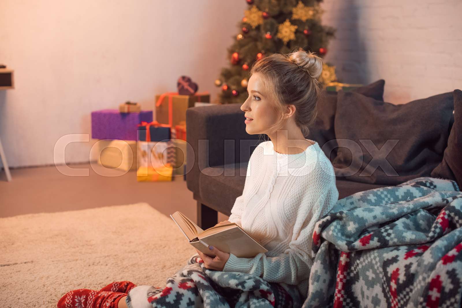 Charming Girl Smiling And Reading Book At Home On Christmas Eve Stock 
