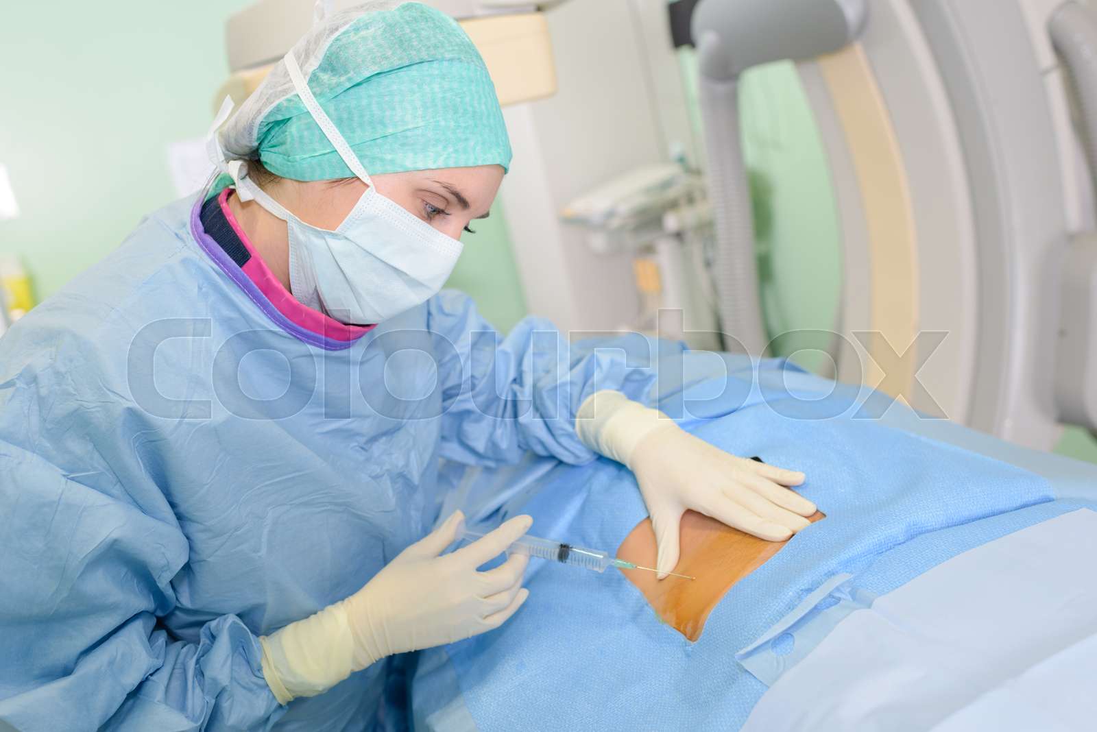 Nurse injecting exposed part of patient's body | Stock image | Colourbox