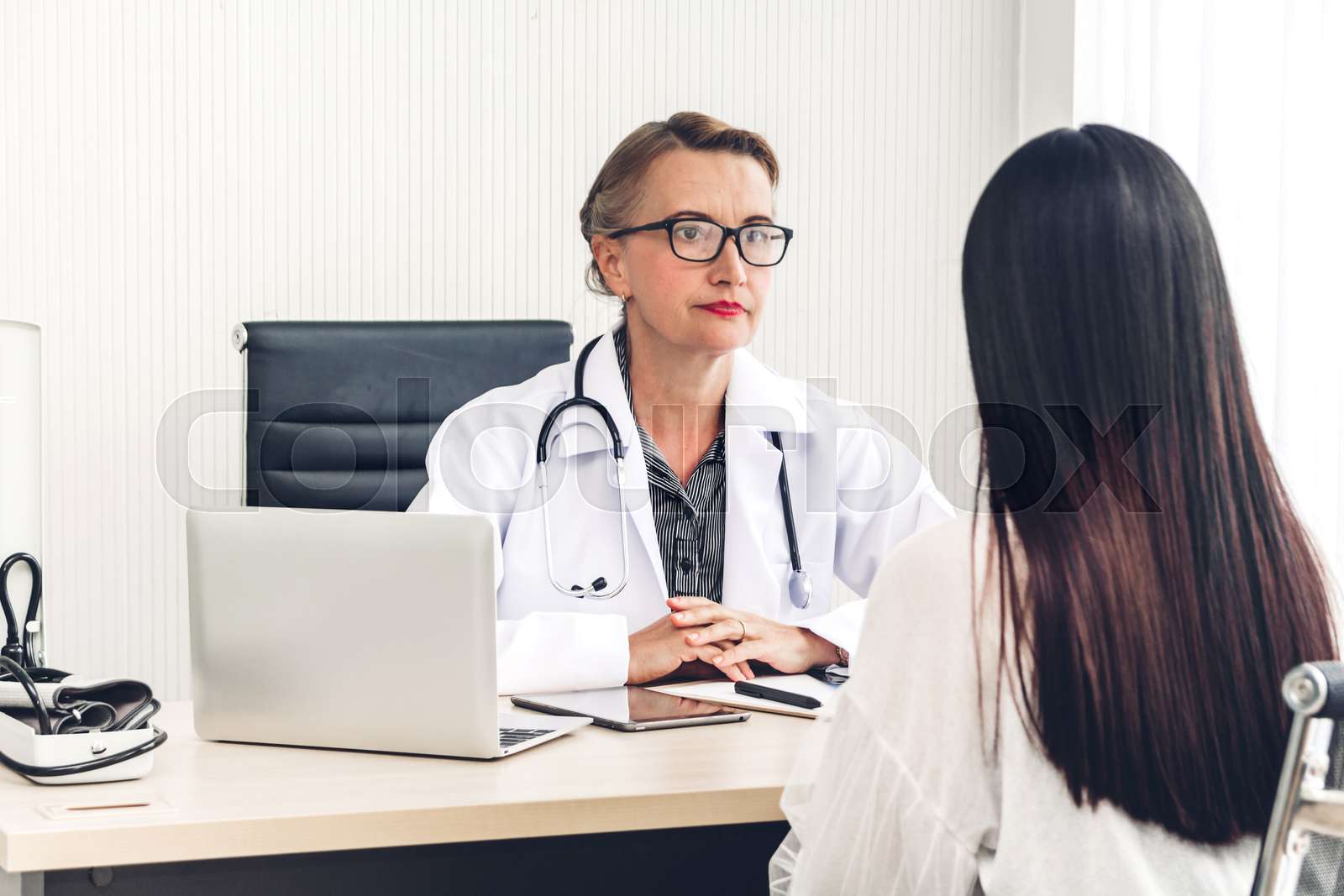 woman discussing health concerns with doctor