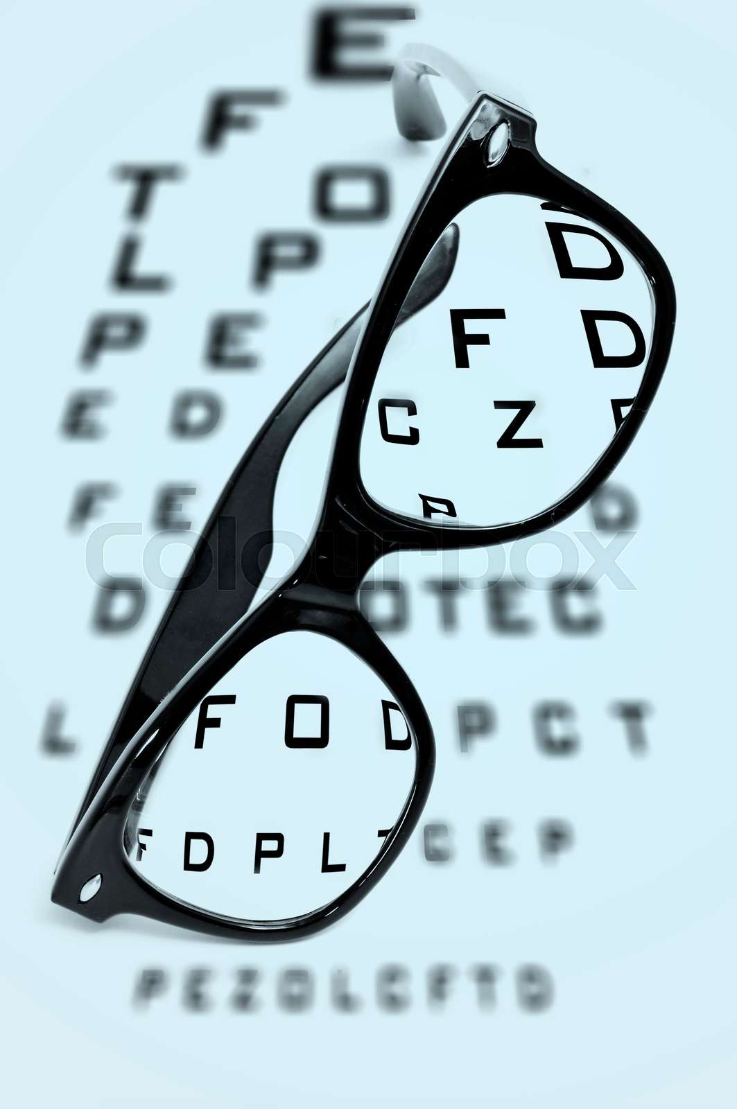 eyeglasses over a blurry eye chart Stock image Colourbox