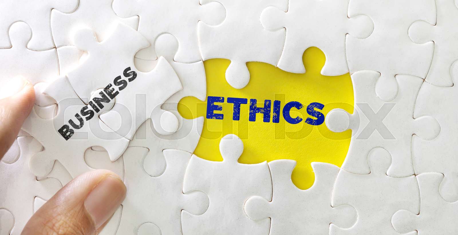 Close up piece of white jigsaw puzzle with word of Business Ethics ...