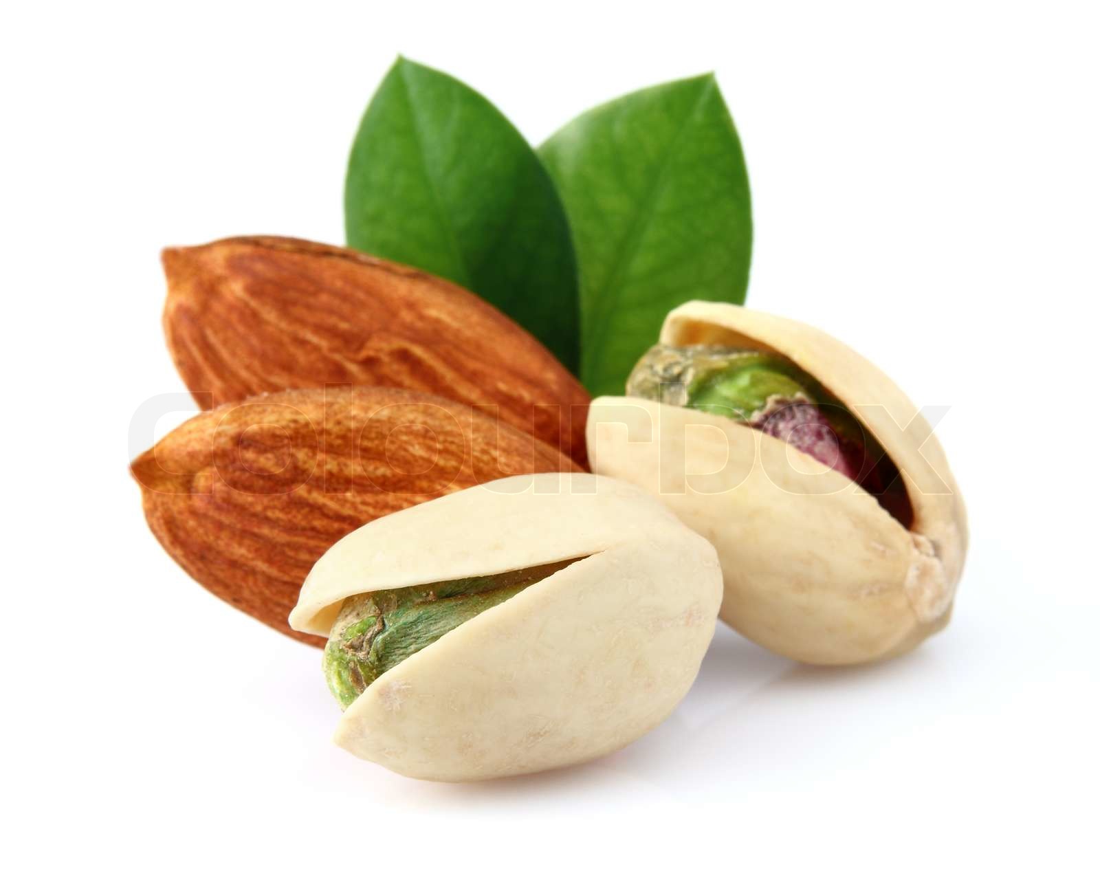 Pistachio and almonds with leaves Stock image Colourbox