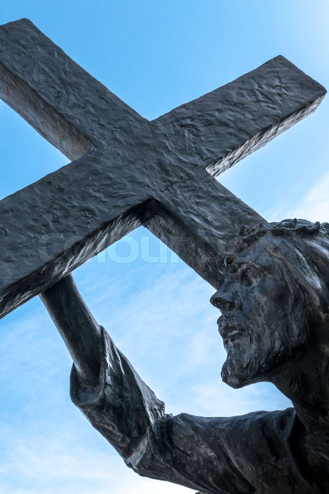 Bronze statue of Jesus carrying his cross | Stock image | Colourbox