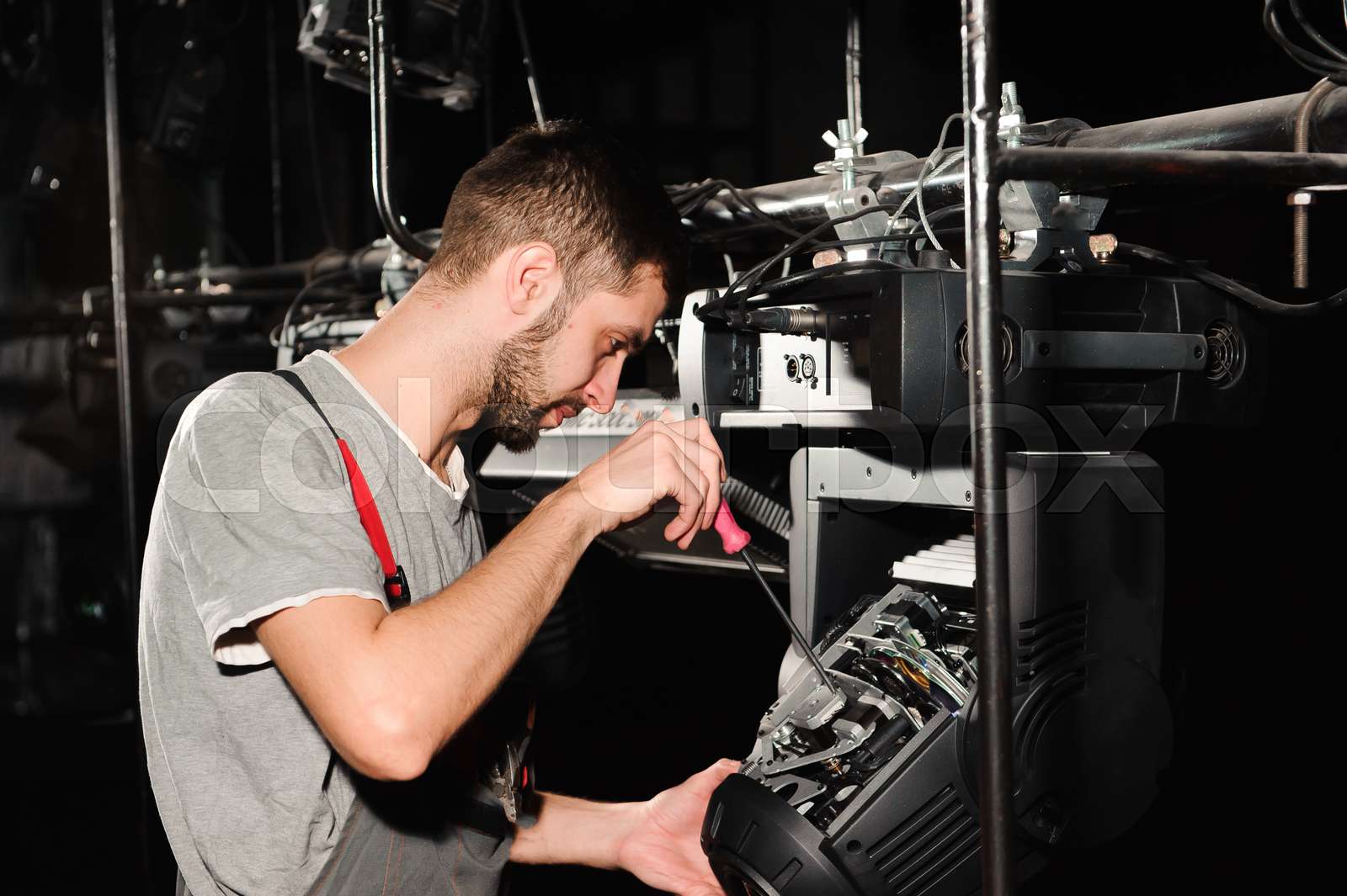 The lighting engineer adjusts the lights on the stage Stock image