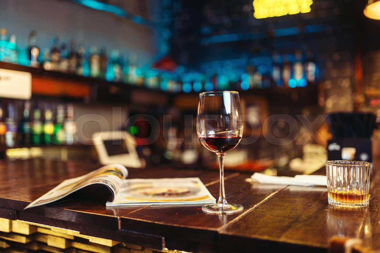 Glass of red wine on wooden bar counter, nobody Stock image Colourbox